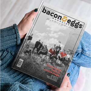 Woman sitting down holding a magazine in both hands